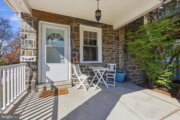 a view of a patio with table and chairs and potted plants