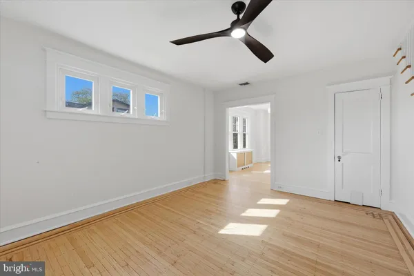 a view of an empty room with wooden floor