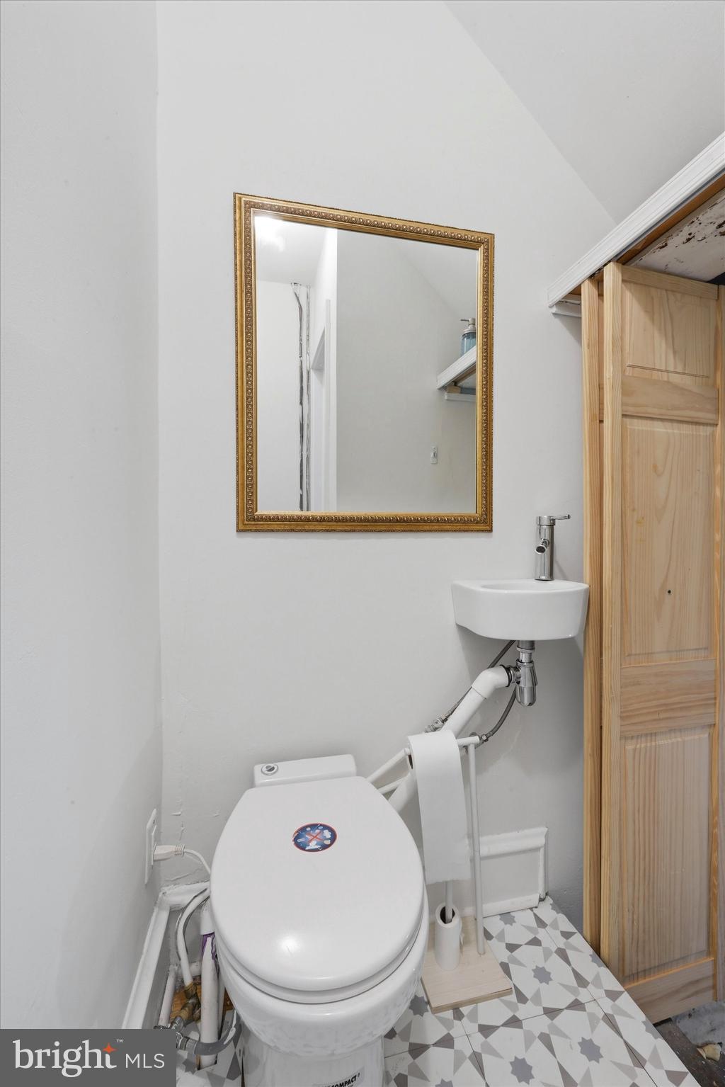 7864 Beverly Boulevard Upper Darby, PA 19082 - Photo 6 of 27 a bathroom with a toilet and a sink