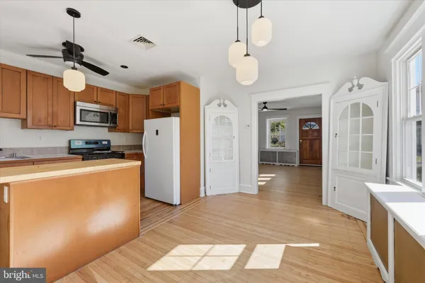 a kitchen with stainless steel appliances a refrigerator sink and microwave