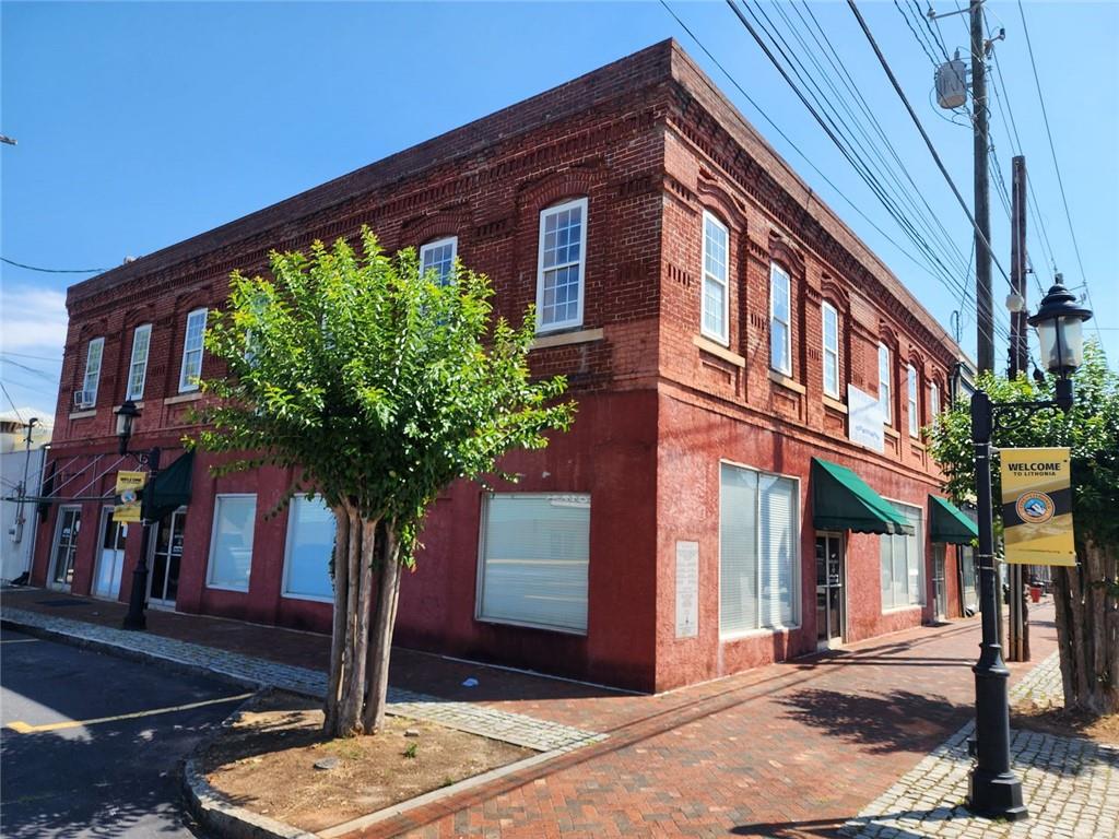 6958 Main Street Lithonia, GA 30058 - Photo 4 of 55 a front view of a building with garden