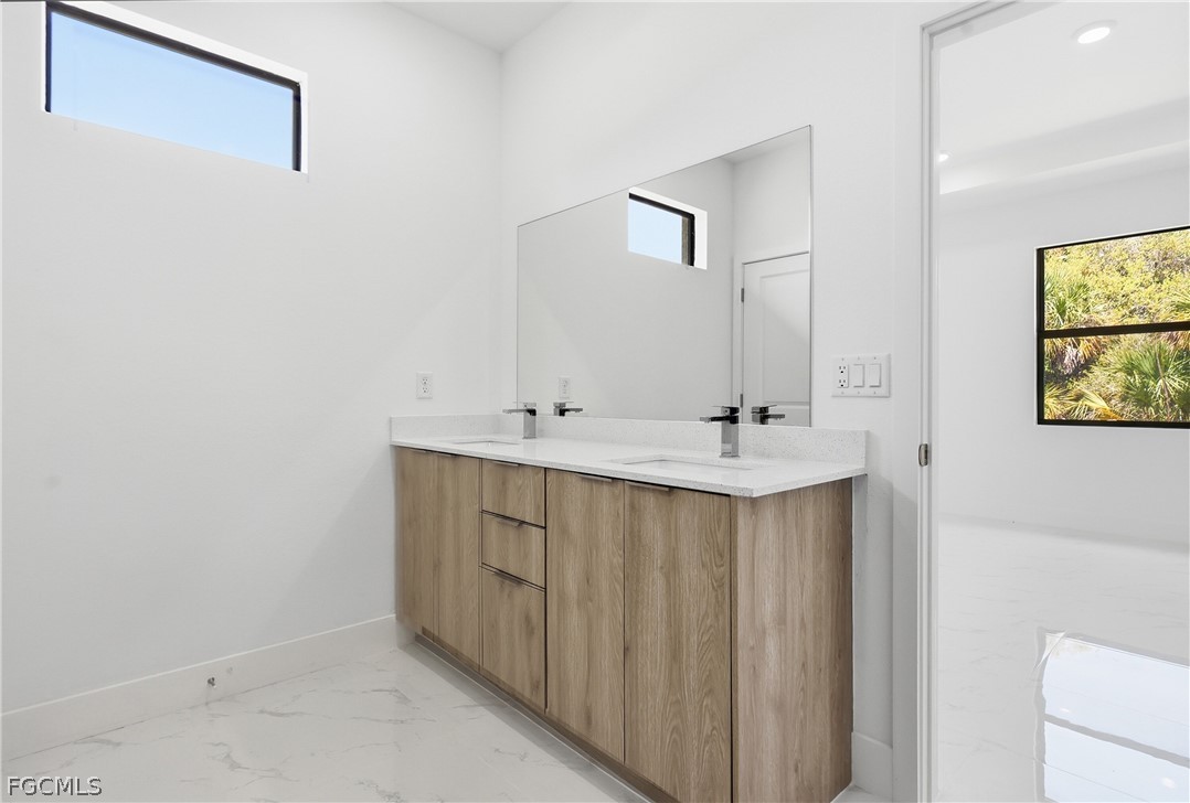 1253 Argosy Road LaBelle, FL 33935 - Photo 15 of 35 a bathroom with a sink and a mirror