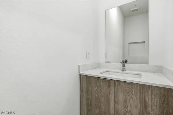 a bathroom with a sink a mirror and vanity