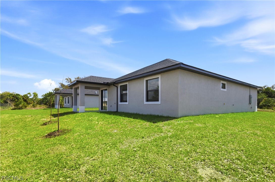 1253 Argosy Road LaBelle, FL 33935 - Photo 32 of 35 a backyard of a house with lots of green space