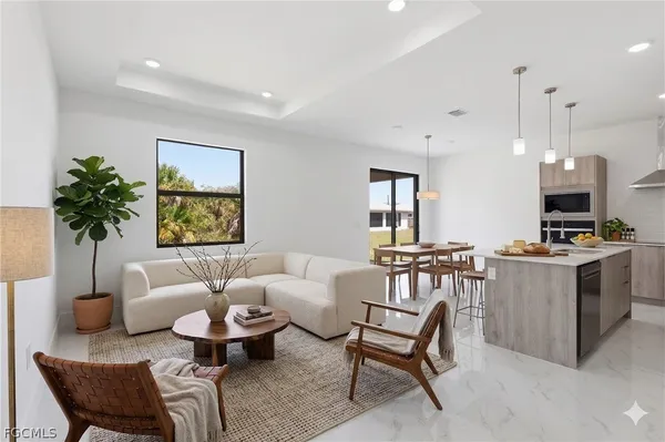 a living room with furniture a table and a potted plant