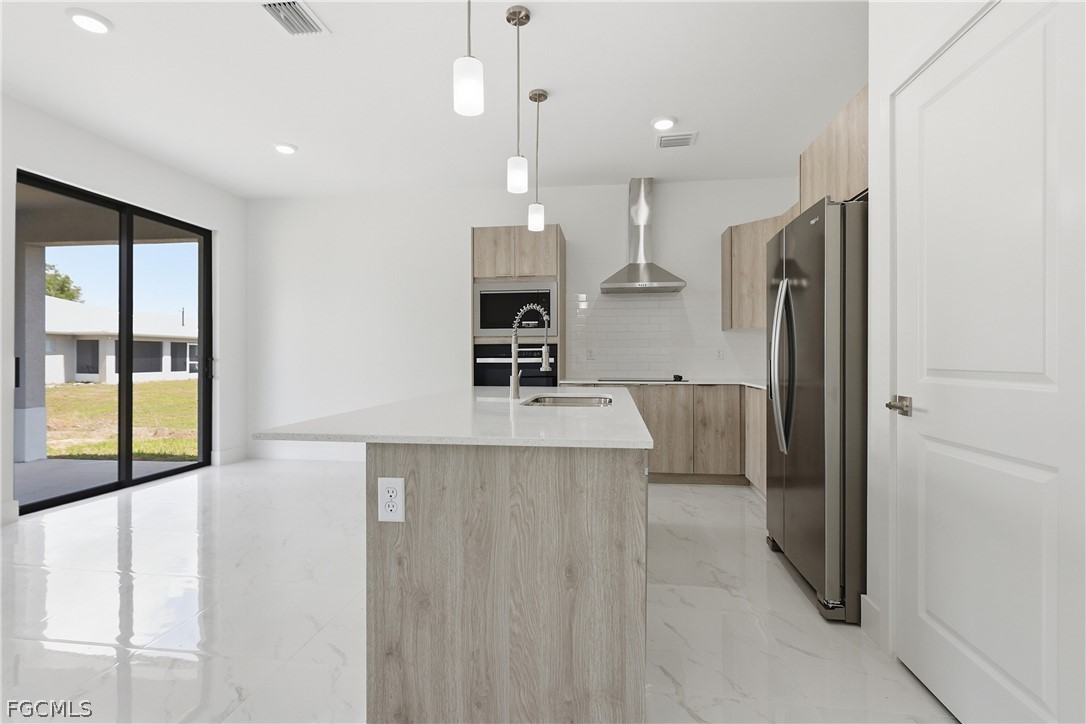1253 Argosy Road LaBelle, FL 33935 - Photo 6 of 35 a kitchen with stainless steel appliances a refrigerator and a sink