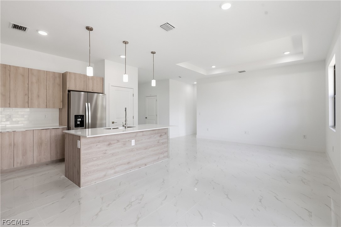 1253 Argosy Road LaBelle, FL 33935 - Photo 7 of 35 a large kitchen with kitchen island white cabinets and stainless steel appliances