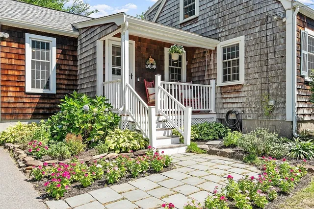 a front view of a house with a garden