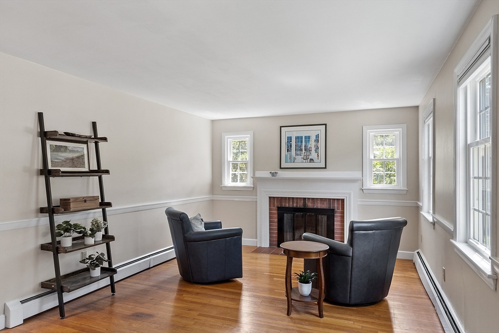 27 Mill Lane Littleton, MA 01460 - Photo 13 of 38 a living room with furniture wooden floor and a fireplace