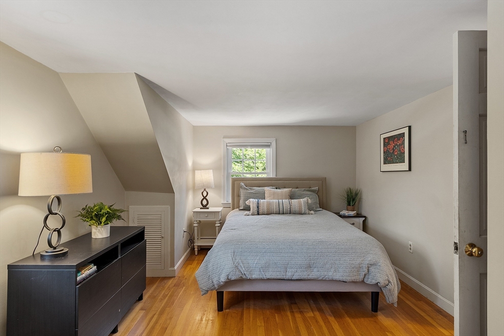 27 Mill Lane Littleton, MA 01460 - Photo 18 of 38 a bedroom with a bed and a lamp on dresser