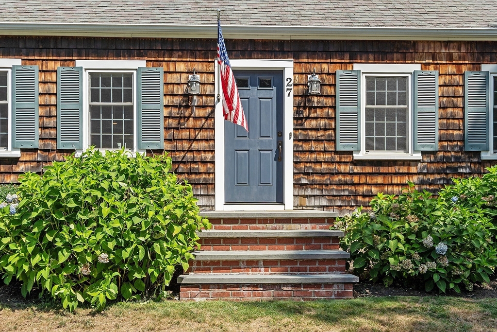27 Mill Lane Littleton, MA 01460 - Photo 2 of 38 a front view of a house with a garden and entryway