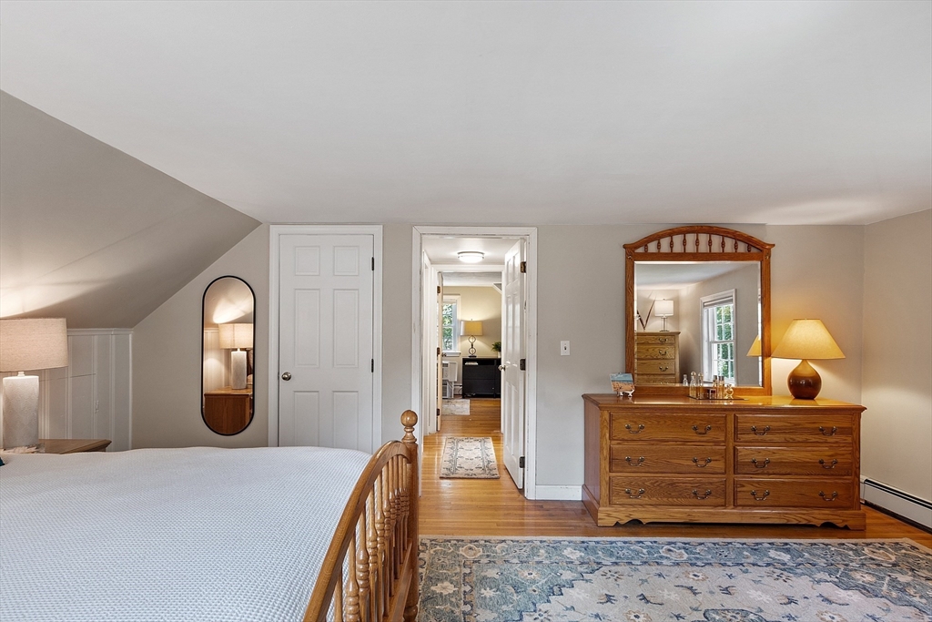 27 Mill Lane Littleton, MA 01460 - Photo 24 of 38 a bedroom with a bed and wooden floor