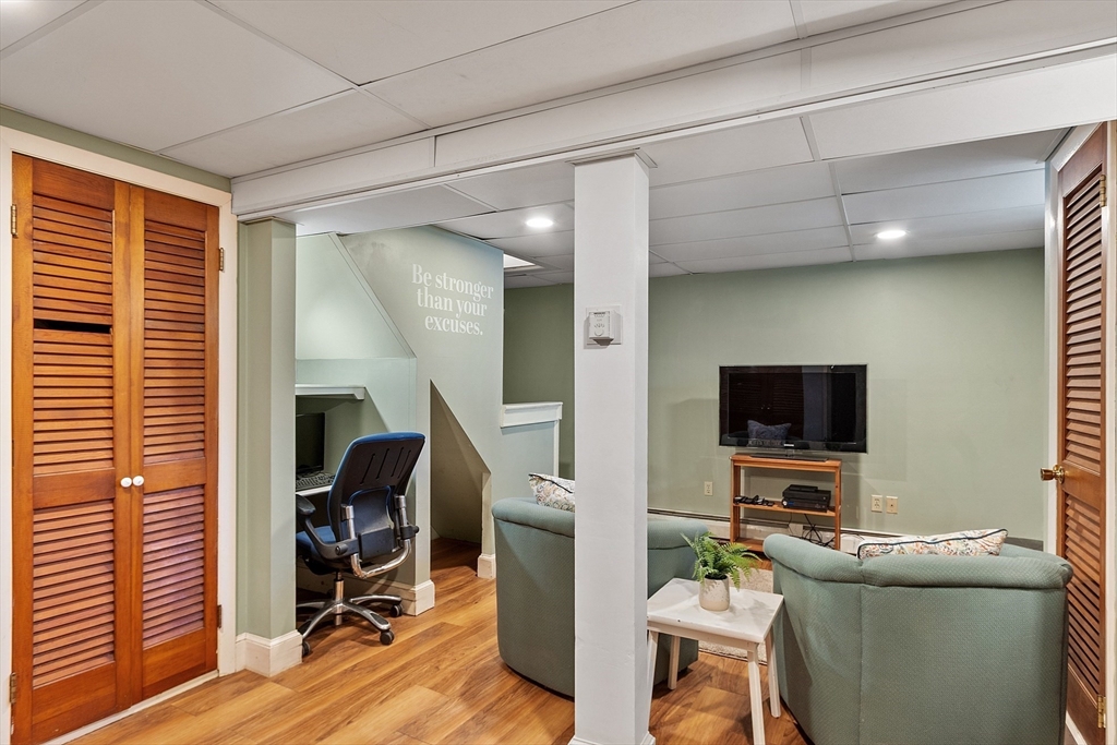 27 Mill Lane Littleton, MA 01460 - Photo 26 of 38 a living room with furniture and a flat screen tv