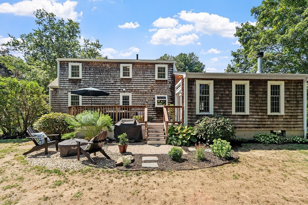 27 Mill Lane Littleton, MA 01460 - Photo 28 of 38 a house view with a sitting space and garden space
