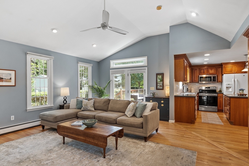 27 Mill Lane Littleton, MA 01460 - Photo 7 of 38 a living room with furniture fireplace and large windows