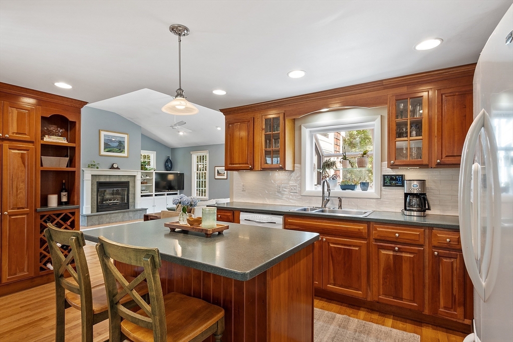 27 Mill Lane Littleton, MA 01460 - Photo 10 of 38 a kitchen with stainless steel appliances granite countertop a sink a stove and a wooden floors