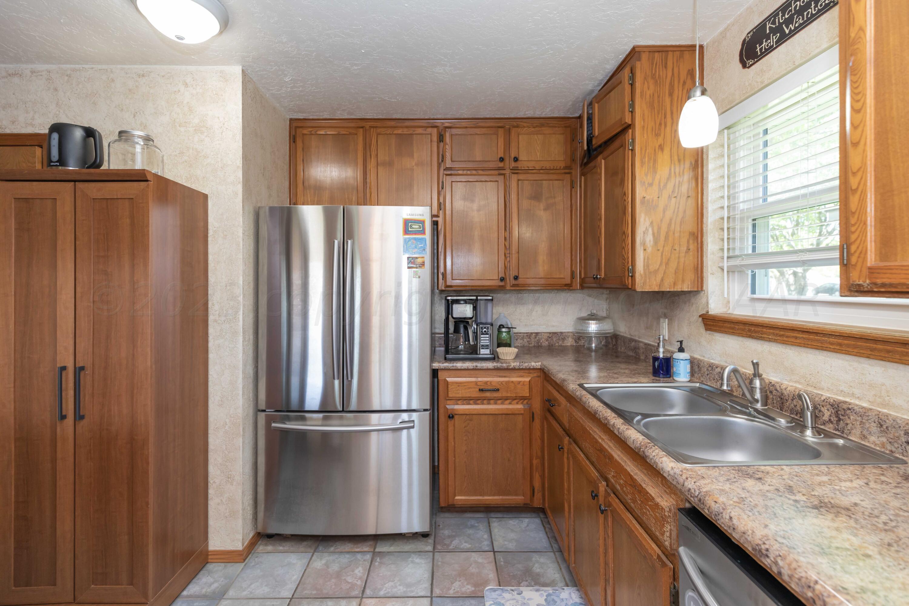 4205 Jamie Trail Amarillo, TX 79110 - Photo 13 of 36 a kitchen with stainless steel appliances granite countertop a refrigerator a sink a stove and island