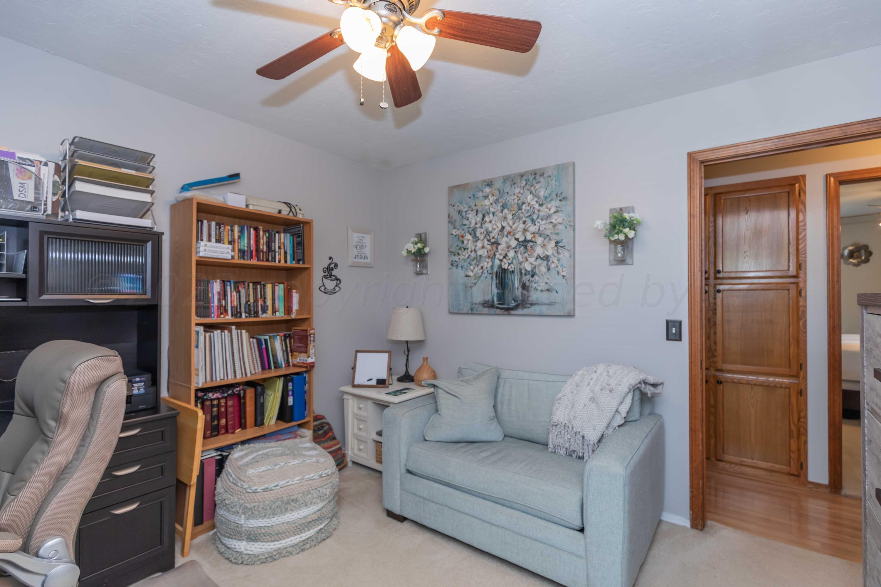 4205 Jamie Trail Amarillo, TX 79110 - Photo 21 of 36 a living room with furniture and a book shelf