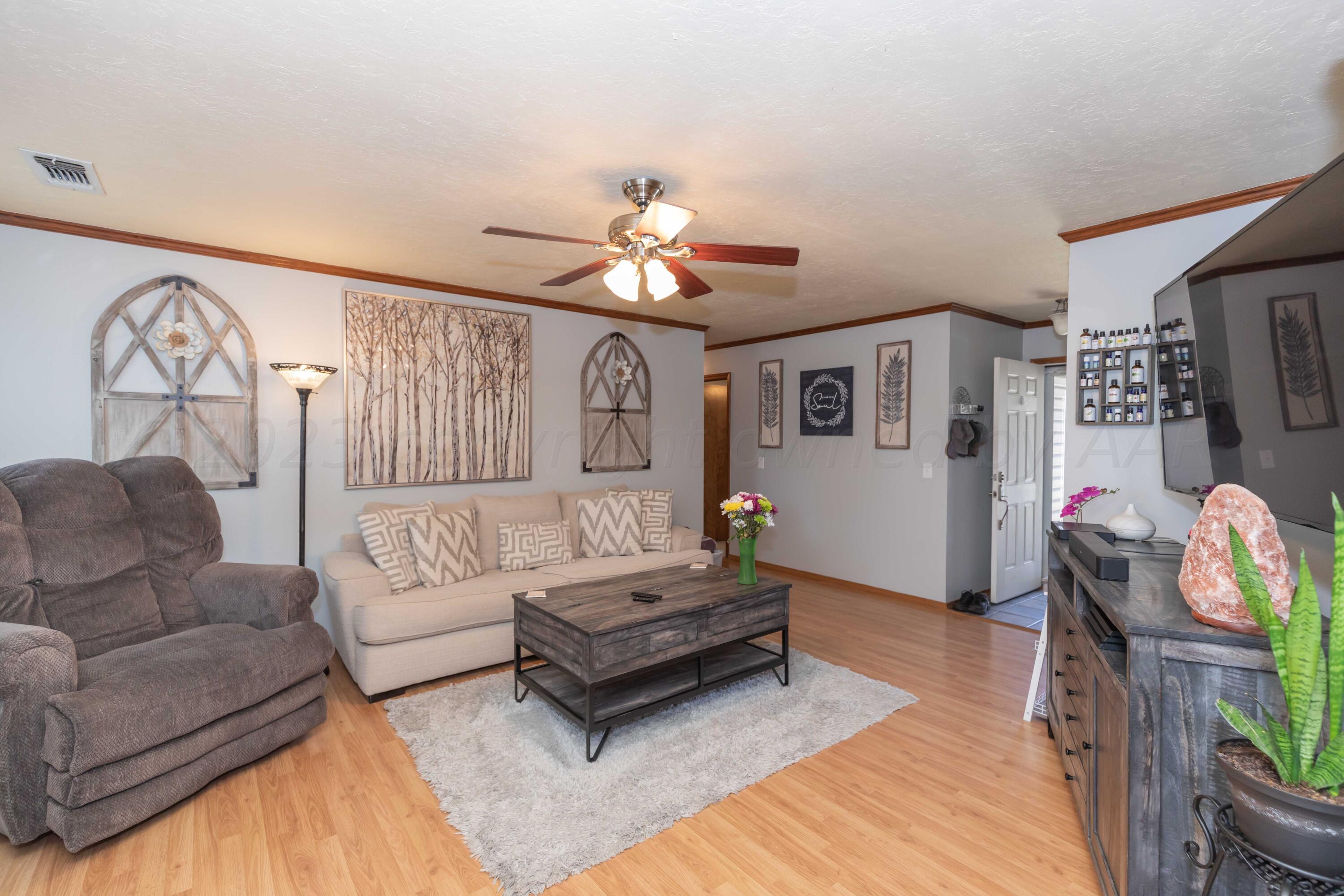 4205 Jamie Trail Amarillo, TX 79110 - Photo 5 of 36 a living room with furniture and a chandelier