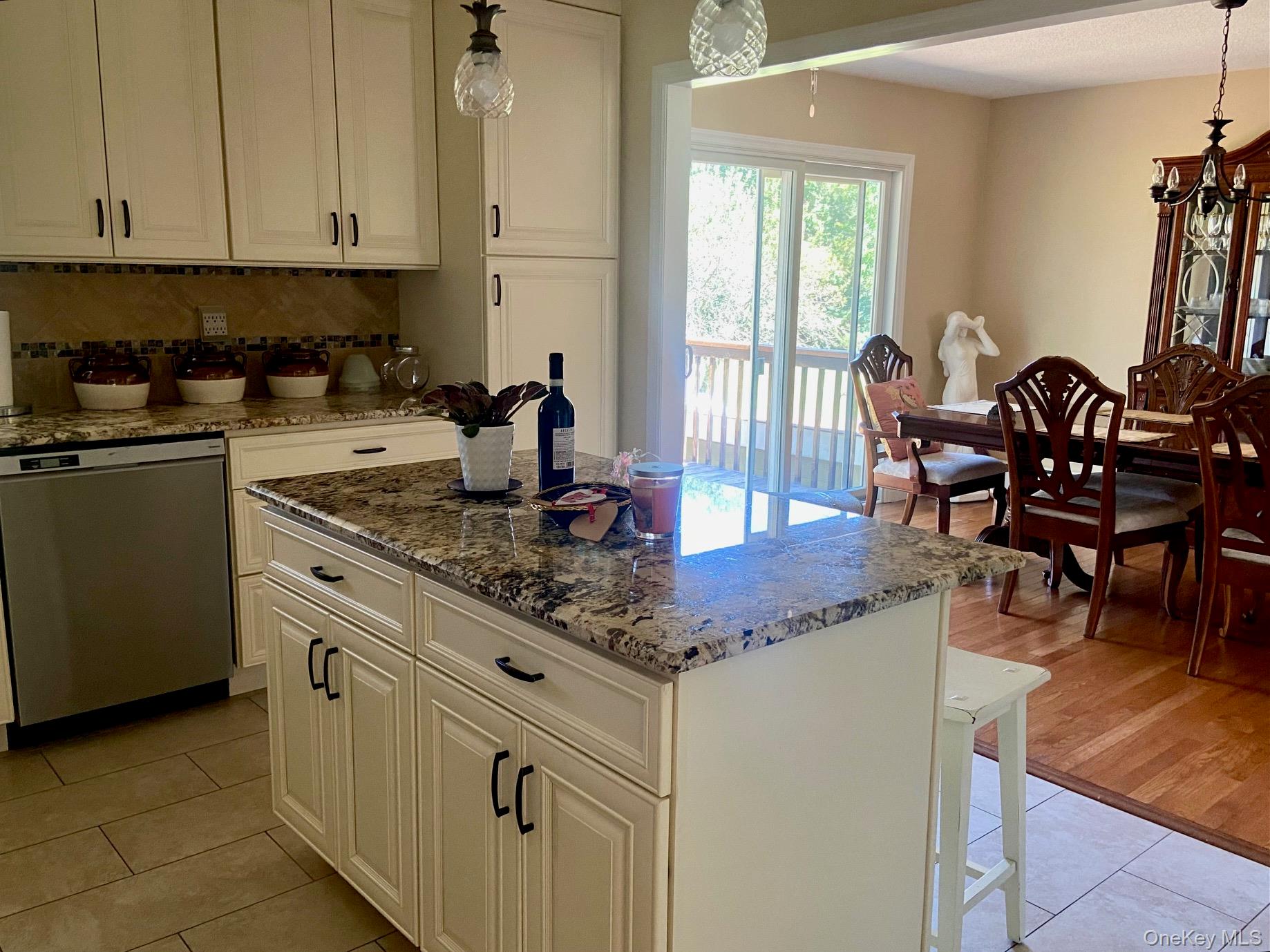 253 Ackertown Road Monsey, NY 10952 - Photo 11 of 38 Kitchen with dark stone counters, pendant lighting, dishwasher, a kitchen island, and backsplash