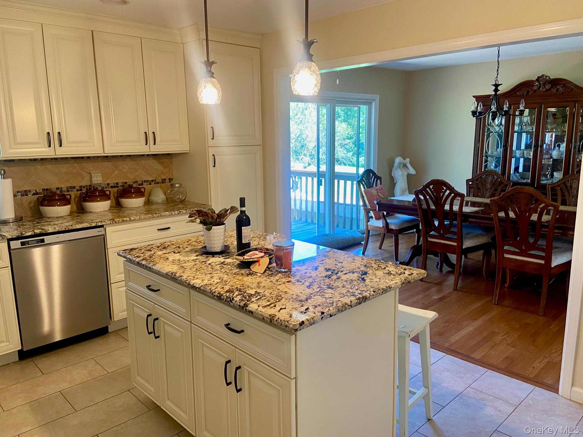 253 Ackertown Road Monsey, NY 10952 - Photo 12 of 38 Kitchen featuring pendant lighting, light stone counters, and decorative backsplash