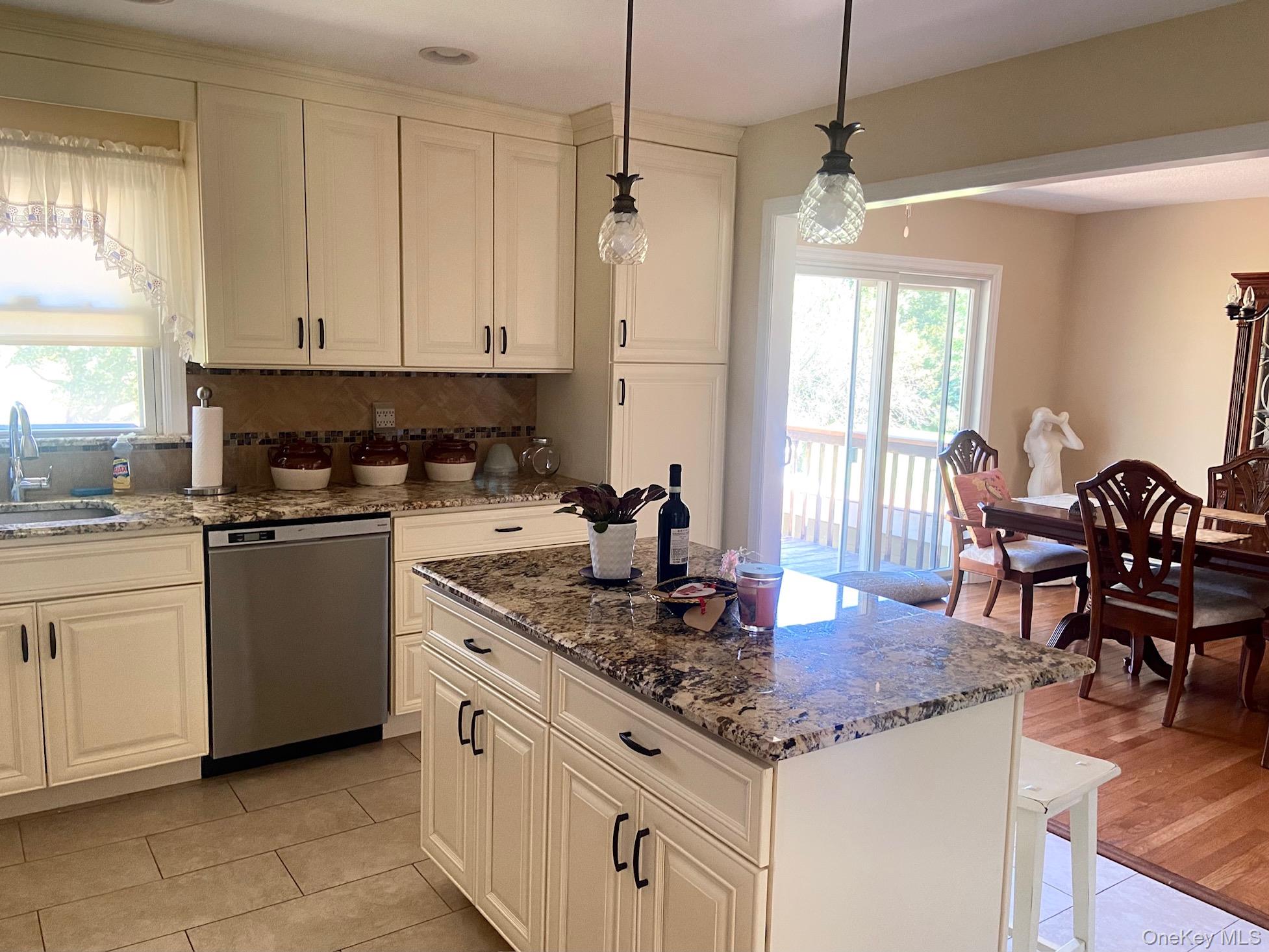 253 Ackertown Road Monsey, NY 10952 - Photo 14 of 38 Kitchen with dark stone counters, stainless steel dishwasher, backsplash, and a center island