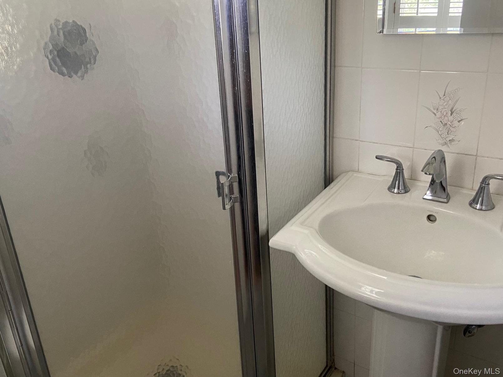 253 Ackertown Road Monsey, NY 10952 - Photo 21 of 38 Bathroom with tile walls and a shower stall in primary bedroom