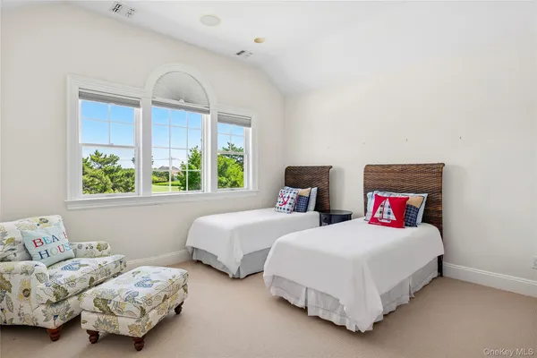 a bedroom with two beds and a window