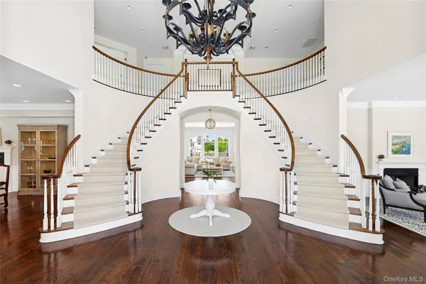 a view of a hallway with furniture and wooden floor