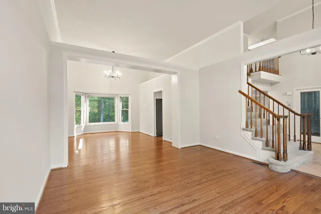 a view of room with window and wooden floor
