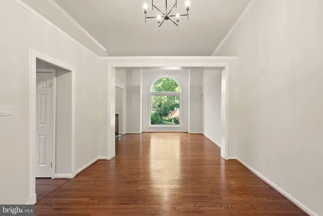 a kitchen with stainless steel appliances kitchen island granite countertop a stove top oven a sink dishwasher a dining table and chairs with wooden floor