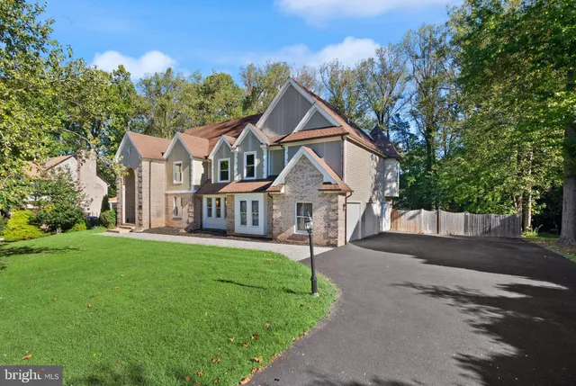 a front view of a house with yard and green space