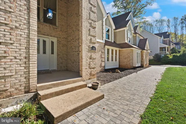 a view of staircase with lots of frames on wall and a window