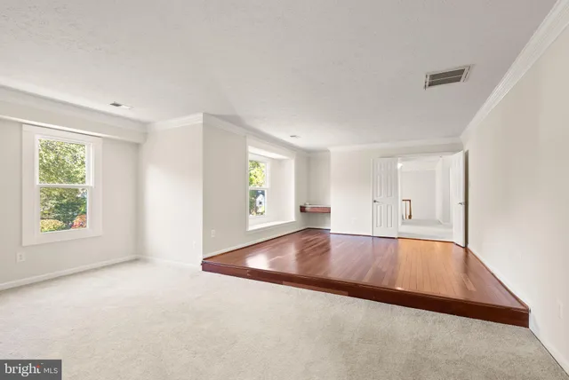 a view of a house with a wooden deck