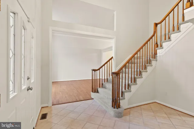 an empty room with wooden floor and a cabinet