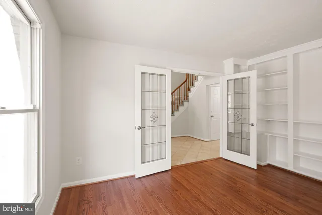wooden floor in an empty room with a window