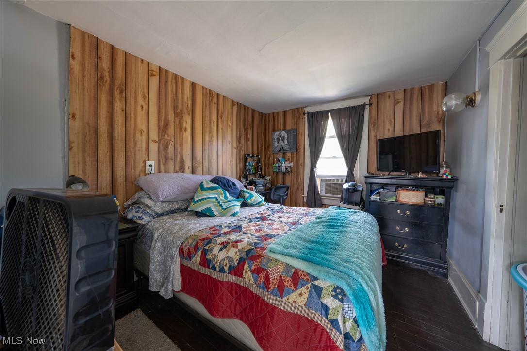 1709 Elm Road Northeast Warren, OH 44483 - Photo 13 of 21 Bedroom with wood walls and dark wood-type flooring