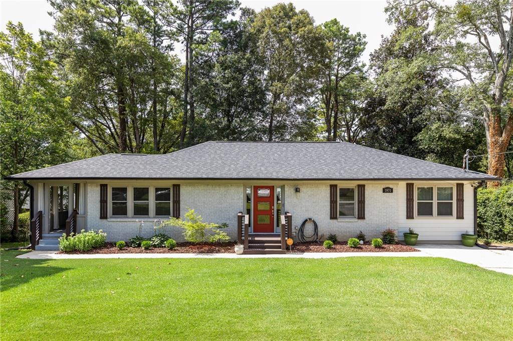 1971 Valencia Road Decatur, GA 30032 - Photo 1 of 1 a front view of a house with yard patio and green space