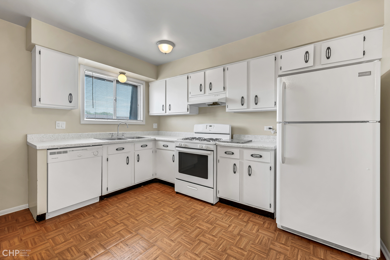 3750 Salem Walk, Unit B2 Northbrook, IL 60062 - Photo 6 of 15 a kitchen with cabinets appliances a sink and a window