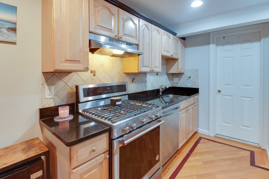 10 Maple Avenue, Unit 3 Andover, MA 01810 - Photo 5 of 11 a kitchen with stainless steel appliances granite countertop a stove and a refrigerator