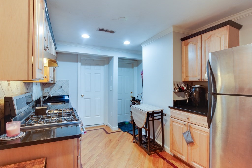 10 Maple Avenue, Unit 3 Andover, MA 01810 - Photo 6 of 11 a kitchen with a stove a refrigerator and a stove top oven
