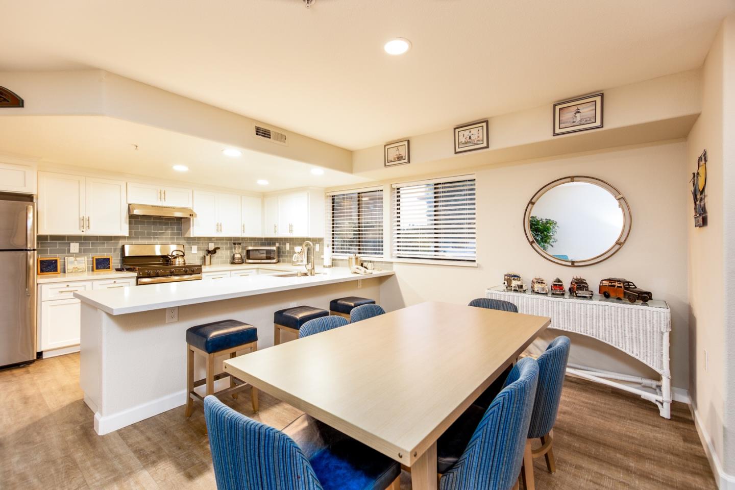 a large kitchen with kitchen island a stove a sink a dining table and chairs