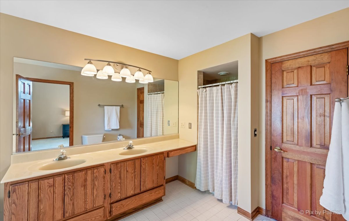 35W723 Parsons Road Algonquin, IL 60102 - Photo 22 of 52 a bathroom with a double vanity sink and a mirror