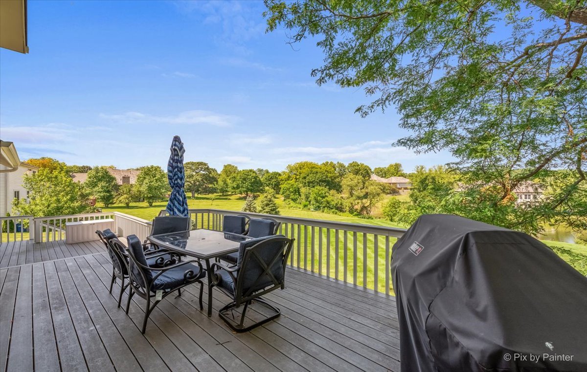 35W723 Parsons Road Algonquin, IL 60102 - Photo 41 of 52 a view of a balcony with table and chairs and wooden floor