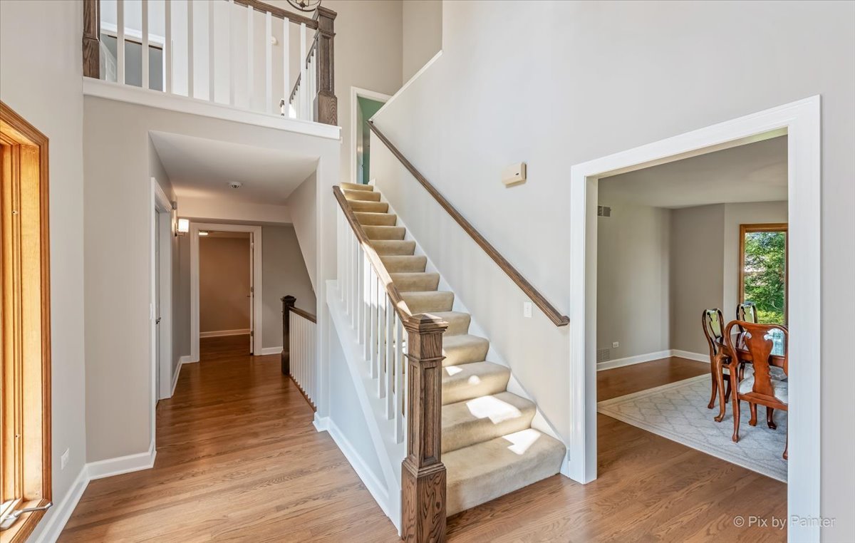 35W723 Parsons Road Algonquin, IL 60102 - Photo 7 of 52 a view of a hallway with wooden floor and stairs