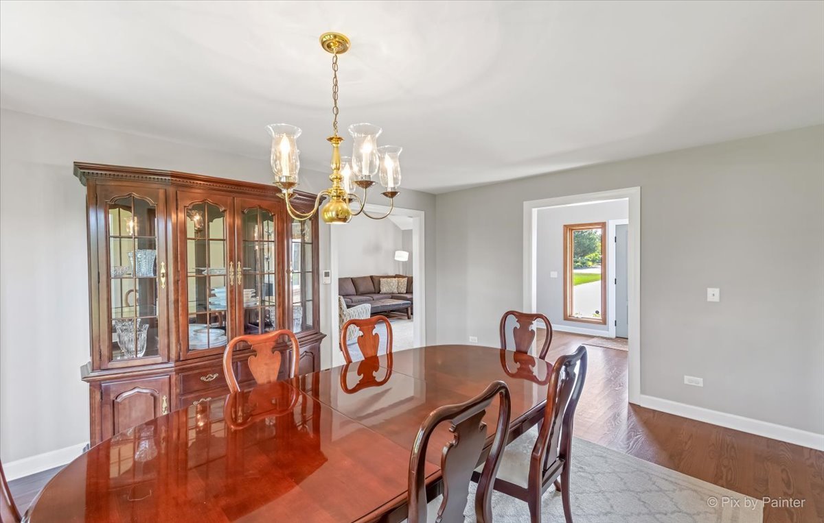 35W723 Parsons Road Algonquin, IL 60102 - Photo 9 of 52 a view of a dining room with furniture a chandelier and wooden floor