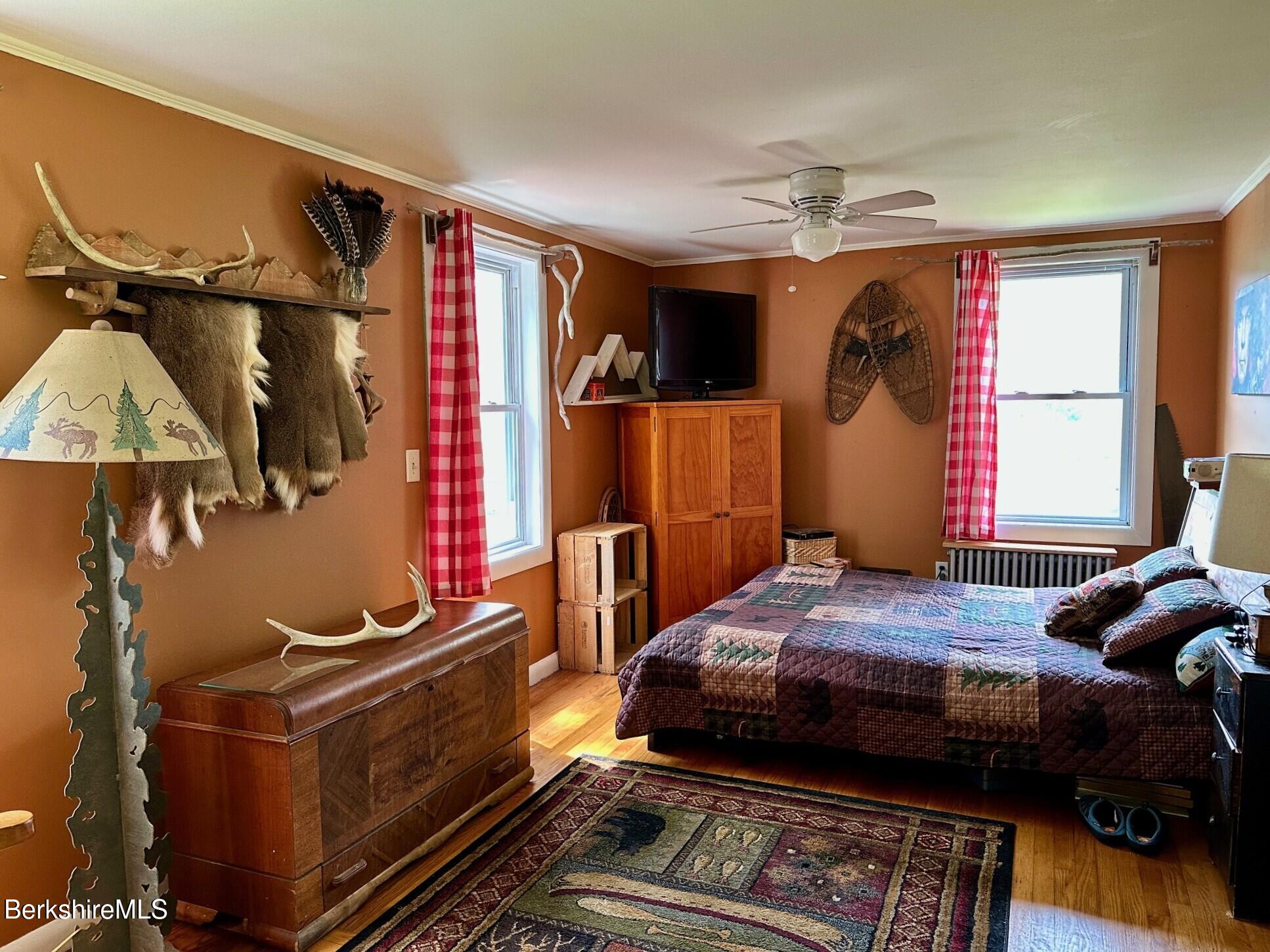 1872 North Main Road Otis, MA 01253 - Photo 13 of 33 a bedroom with a bed and wooden floor