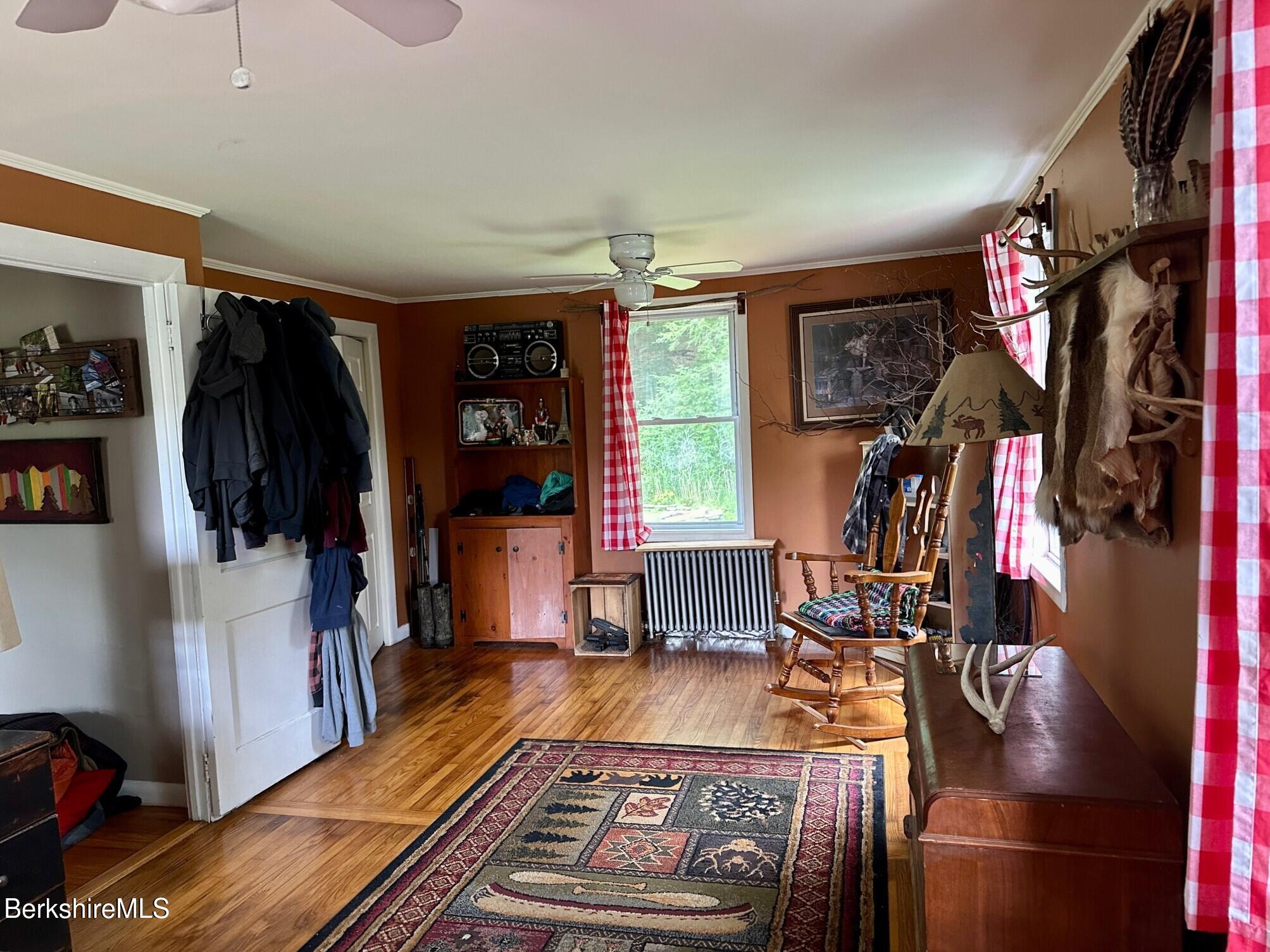 1872 North Main Road Otis, MA 01253 - Photo 14 of 33 a living room with furniture a flat screen tv and a walk in closet