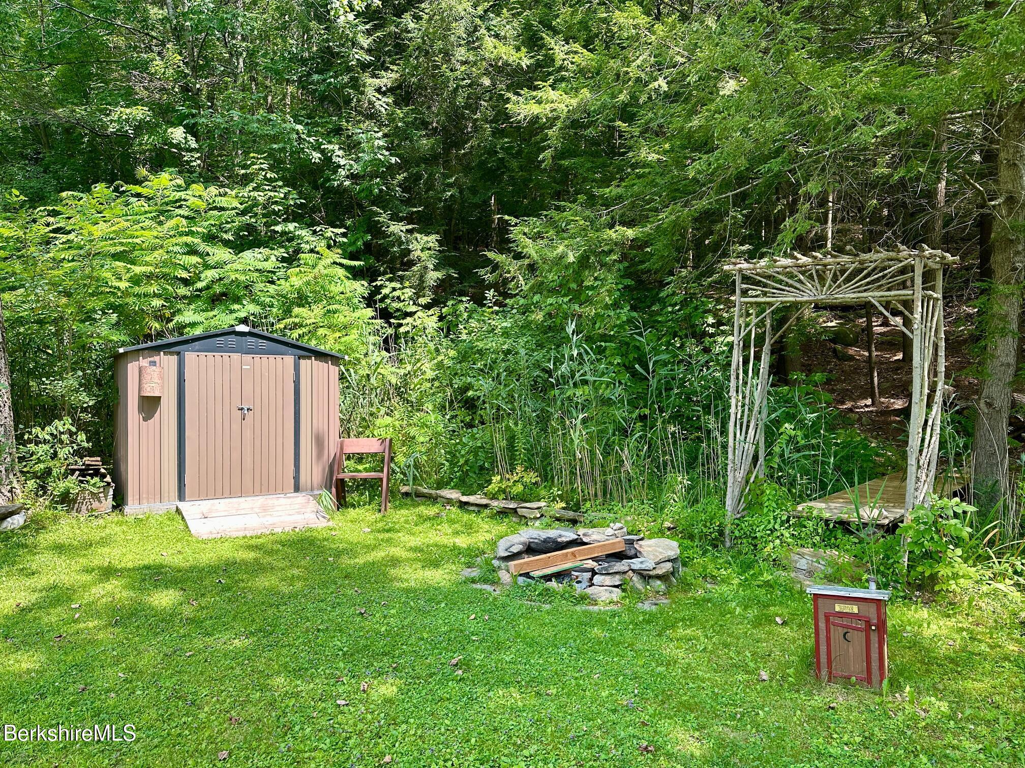 1872 North Main Road Otis, MA 01253 - Photo 23 of 33 a view of backyard with a barn and large trees
