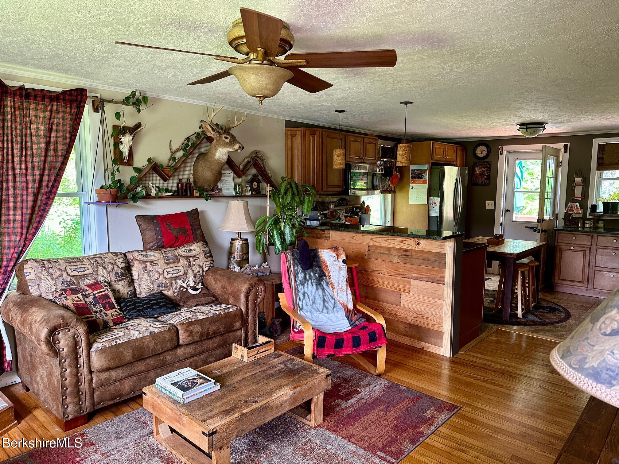 1872 North Main Road Otis, MA 01253 - Photo 3 of 33 a living room with furniture a rug and a chandelier